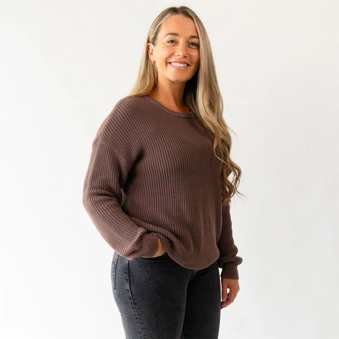 A nurse wearing a cozy custom sweater while attending to patients in a hospital environment.