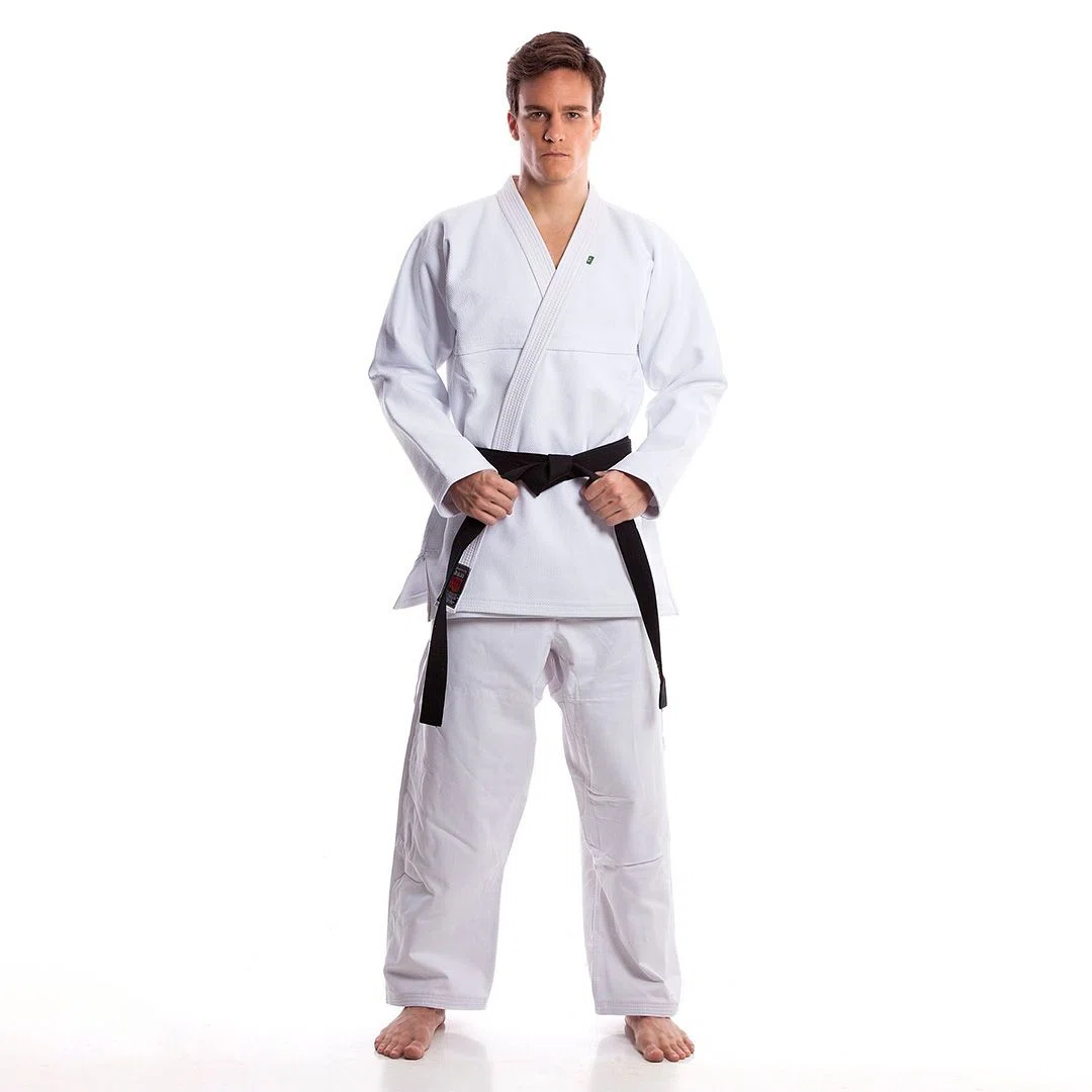 Martial arts team wearing custom logo jiu jitsu uniforms with embroidered patches and branding, standing proudly together.