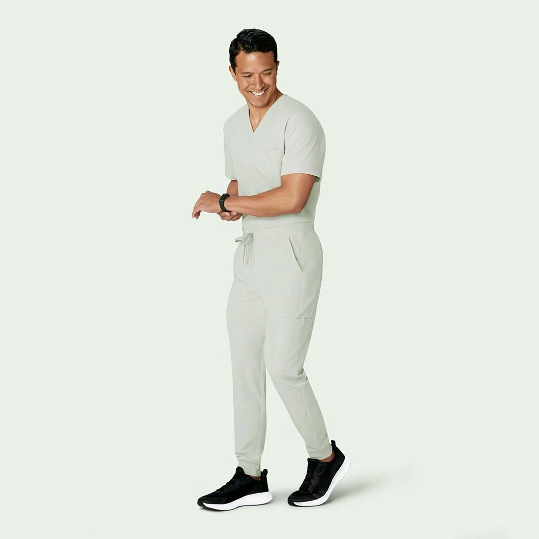 Healthcare professional wearing flexible black jogger scrubs showcasing comfort and ease of movement in a hospital setting.