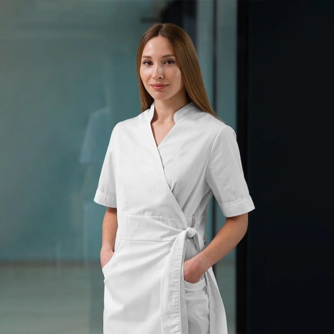 Durable branded salon smock showcased in a salon environment, highlighting reinforced stitching and stain-resistant fabric.
